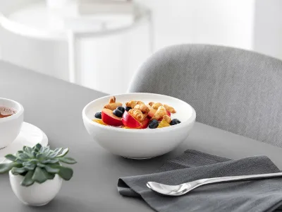 Muesli served in a white NewMoon bowl A healthy breakfast consisting of yoghurt with mixed berries and muesli, served in a white NewMoon bowl.