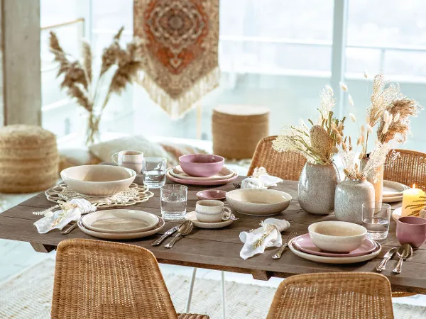 Gedeckter Tisch im natürlichen Look mit Perlemor Kollektion Ein Esstisch mit Rattanstühlen und Weidenkörben gedeckt mit Perlemor Geschirr von like. by Villeroy & Boch.