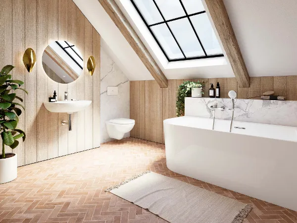O.novo Badewanne mit Waschbecken und Toilette. Ein modernes Bad mit Badewanne, Wandwaschbecken, rundem Spiegel und WC aus der Kollektion O.novo. Ein großes Oberlicht und eine Topfpflanze werten den Raum auf. Holzakzente und Fischgrätenfliesen geben dem Raum einen rustikalen Touch.